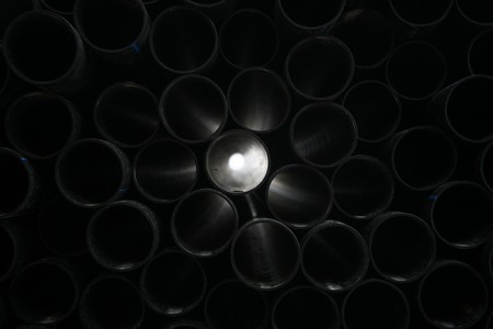gray pvc pipes stacked in construction site の写真素材