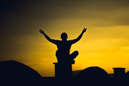 Young man meditating outdoorsの写真素材