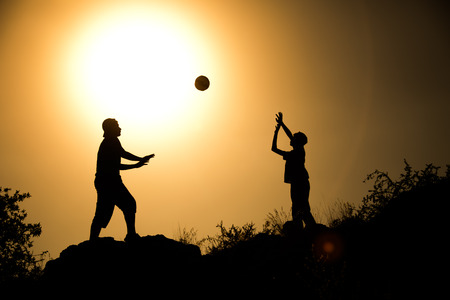 two brothers, boys play at sunset.の写真素材