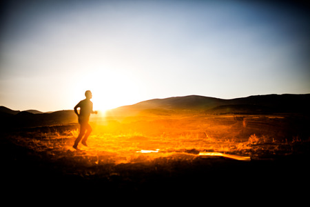 silhouette of man in the mountainous area athletesの写真素材