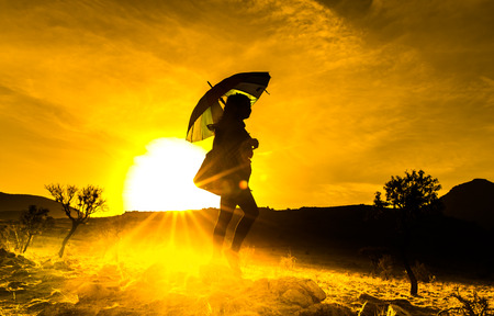 A beautiful woman silhouette at sunsetの写真素材