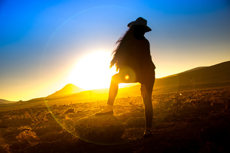 A beautiful woman silhouette at sunsetの写真素材