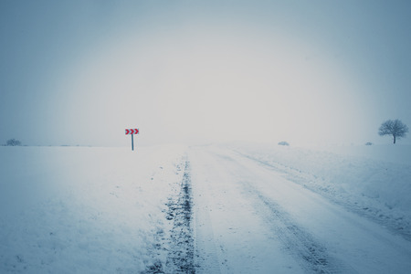 winding country road in winterの写真素材