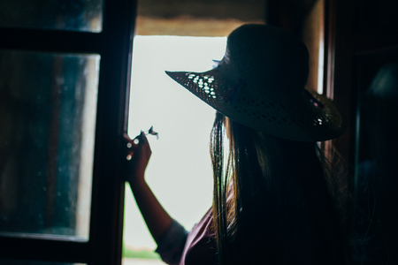 woman facing out of the windowの写真素材