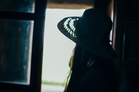 woman facing out of the windowの写真素材