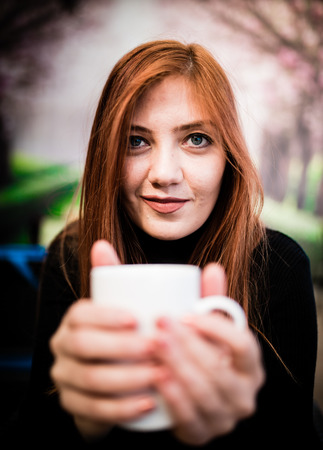 Beautiful girl drinking coffee at the coffee shop