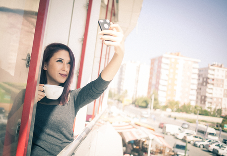 Beautiful girl drinking coffee at the coffee shopの写真素材