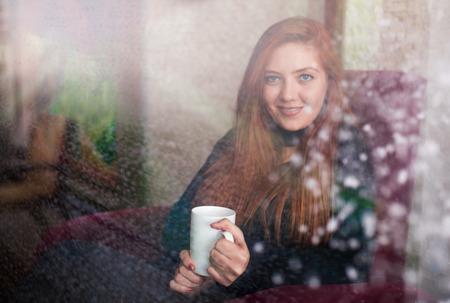 Beautiful girl drinking coffee at the coffee shopの写真素材