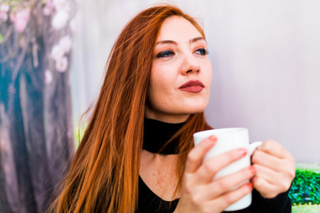 Beautiful girl drinking coffee at the coffee shopの写真素材