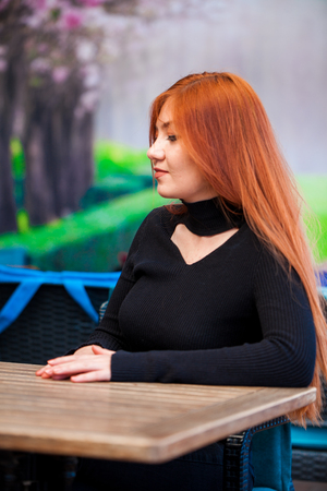 Beautiful girl drinking coffee at the coffee shop