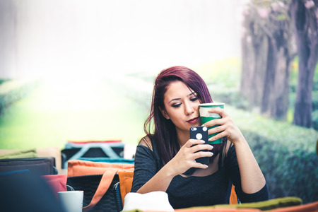 Beautiful girl drinking coffee at the coffee shopの写真素材