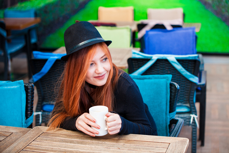 Beautiful girl drinking coffee at the coffee shopの写真素材