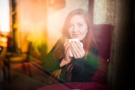 Beautiful girl drinking coffee at the coffee shop