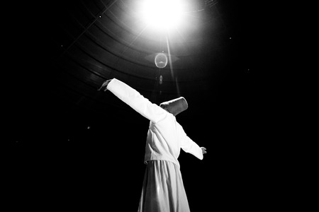 the image of a whirling Dervish in the darknessの写真素材