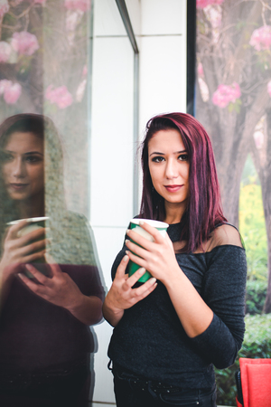 Beautiful girl drinking coffee at the coffee shopの写真素材