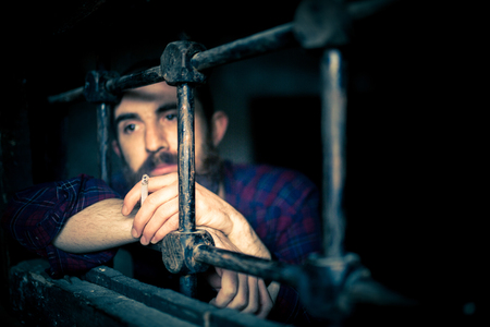 a helpless prisoner between the barsの写真素材