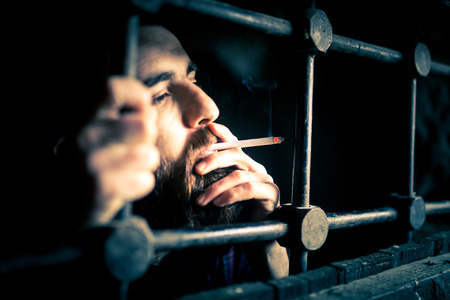 a helpless prisoner between the barsの写真素材