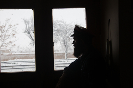 silhouette image of station attendant looking at windowの写真素材