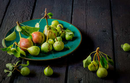 pears on the plate on an aged tableの写真素材
