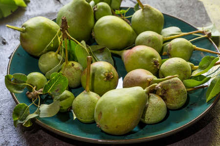 pears on the plate on an aged table