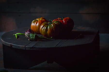 Preparation with vegetables on dark ground in the kitchenの写真素材