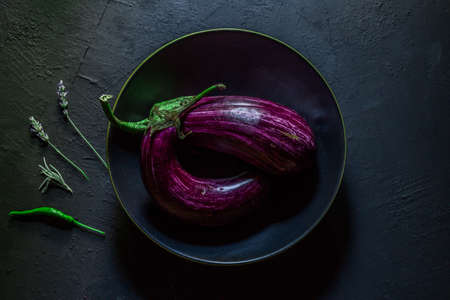 Preparation with vegetables on dark ground in the kitchenの写真素材