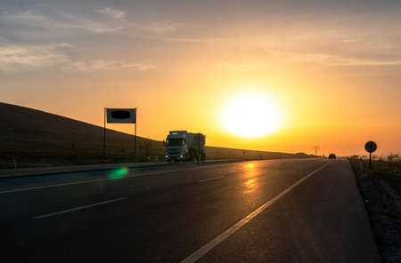 Caravan on the highway at sunset. Freight transportation. Transportation.の写真素材
