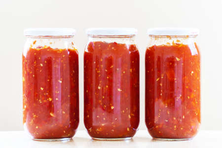 glass jars filled with tomato sauce