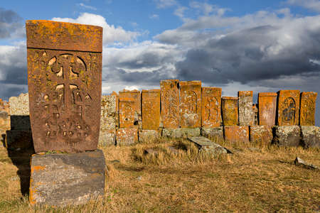Historical tombs and head stones known as Khachkars or Armenian cross stones, in the ruins of the ancient cemetery of Noratus, in Armeniaの写真素材