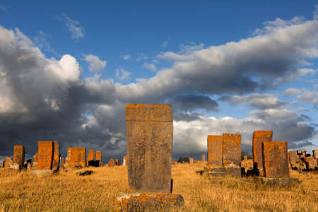 Historical tombs and head stones known as Khachkars or Armenian cross stones, in the ruins of the ancient cemetery of Noratus, in Armeniaの写真素材