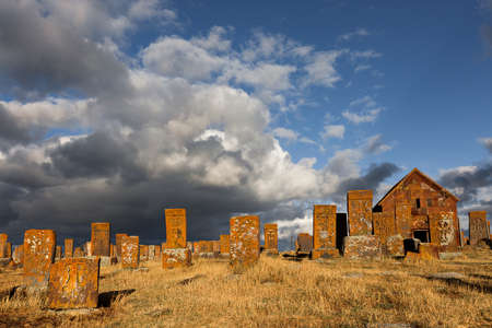 Historical tombs and head stones known as Khachkars or Armenian cross stones, in the ruins of the ancient cemetery of Noratus, in Armeniaの写真素材