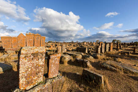 Historical tombs and head stones known as Khachkars or Armenian cross stones, in the ruins of the ancient cemetery of Noratus, in Armeniaの写真素材
