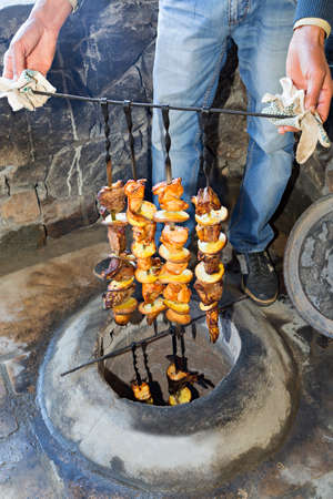 Lamb and chicken kebabs with potatoes on the skewer, out of tandoori oven.の写真素材