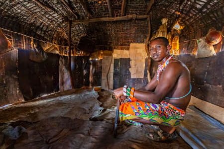Samburu, Kenya - June 25, 2019: Samburu man sitting inside the village house, in Samburu, Kenyaのeditorial素材