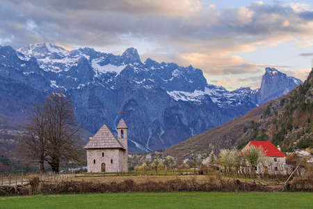 Theth Village and snow capped mountains in Thethi Valley, Albaniaの写真素材