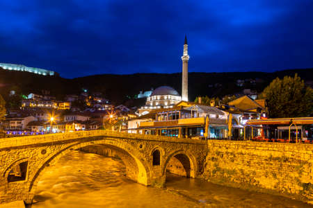 Old stone bridge and Sinan Pasha Mosque, in Prizren, Kosovoのeditorial素材