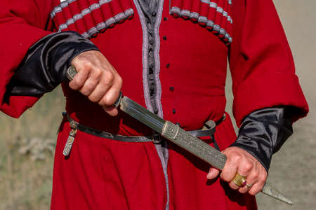 Georgian man in traditional clothes holding the dagger, Caucasus Mountains, Georgiaの写真素材