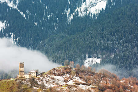 Old house with medieval tower in the Caucasus Mountains, Georgia.の写真素材