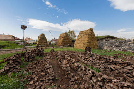 Village scene with stacks of hay and dried cow dungs to use as fuel, Goergia, Caucasusのeditorial素材