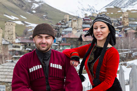Georgian couple in national costumes in village Ushguli, in the Caucasus Mountains, Georgia.のeditorial素材