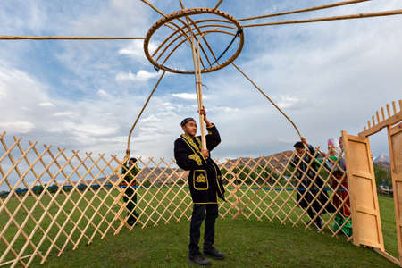 Kazakh men building nomadic tent known as yurt, in Saty Village, Kazakhstan.