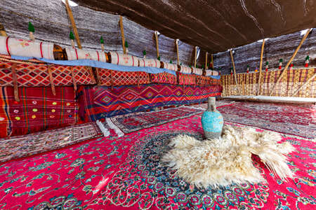 Colorful nomadic tent of Iranian nomadic people known as Qashqai, with a blue vase on the sheep skin, Iranのeditorial素材