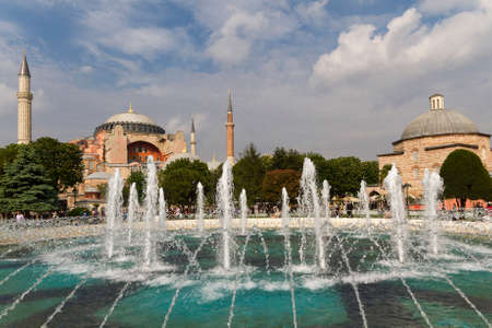 Park in Sultanahmet Square with the fountain and Hagia Sophia in the background, in Istanbul, Turkeyのeditorial素材