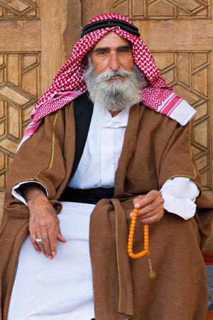 Bearded Turkish elderly man in local costumes with his prayer beads, in Sanliurfa, Turkey.のeditorial素材