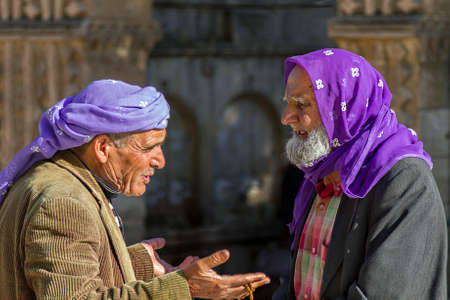 Local elderly men talking to each other in Sanliurfa, Turkey. They wear traditional purple headdress.のeditorial素材
