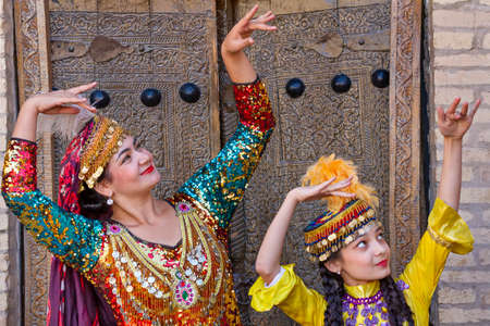 Uzbek ladies in local clothes performing traditional dances, in Khiva, Uzbekistanのeditorial素材