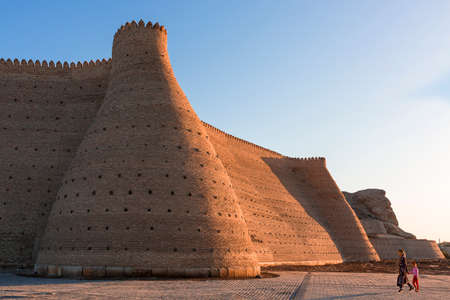 Mother and daughter walking by the city walls of Bukhara in Uzbekistan.のeditorial素材