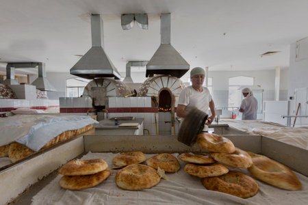 Making bread in a bakery in the Chorsu Bazaar in Tashkent, Uzbekistan.のeditorial素材