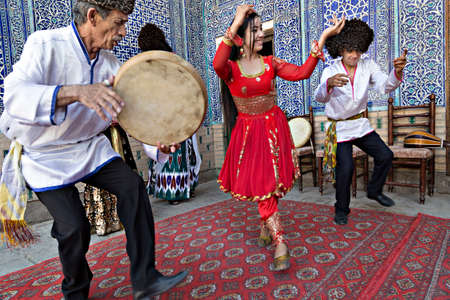 Khorezmian musicians in local dress dancing, in Khiva, Uzbekistanのeditorial素材