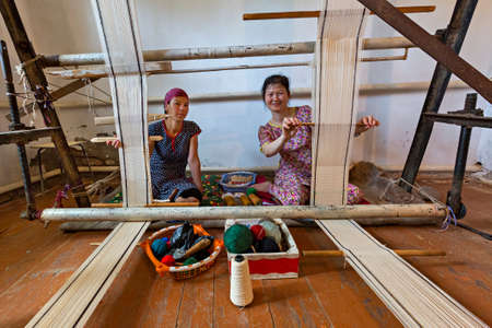 Local women weaving tapestry in Nukus, Uzbekistanのeditorial素材